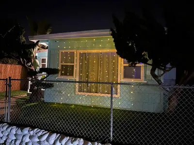 a house with christmas lights in the window at Comfy Cottage Near the Beach in San Diego