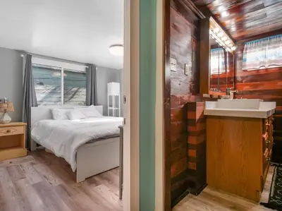 a bedroom with a bed and a sink in it at Comfy Cottage Near the Beach in San Diego