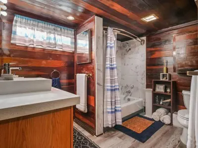 a bathroom with a sink and a toilet and a tub at Comfy Cottage Near the Beach in San Diego