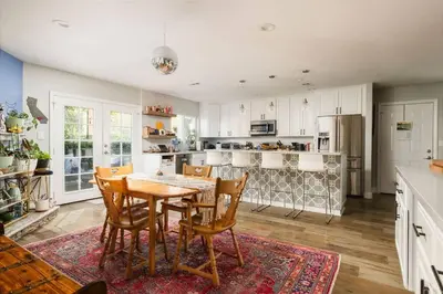 a kitchen with a table and chairs and a refrigerator at Leucadia Beach House - 4 Mins to Moonlight! in Encinitas