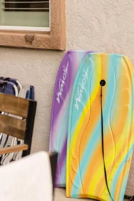 a colorful umbrella sitting on the side of a wall at Leucadia Beach House - 4 Mins to Moonlight! in Encinitas