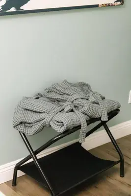 a blanket sitting on top of a stand in a room at Leucadia Beach House - 4 Mins to Moonlight! in Encinitas
