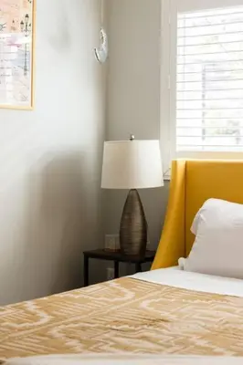 a bedroom with a bed and a lamp on a table at Leucadia Beach House - 4 Mins to Moonlight! in Encinitas