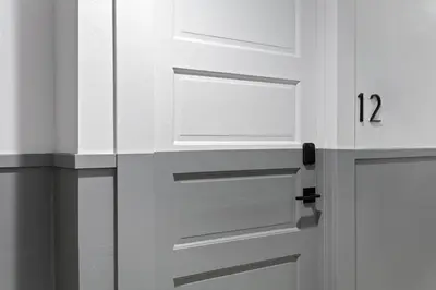 a white door with the number twelve on it at La Ventana Hotel in San Diego