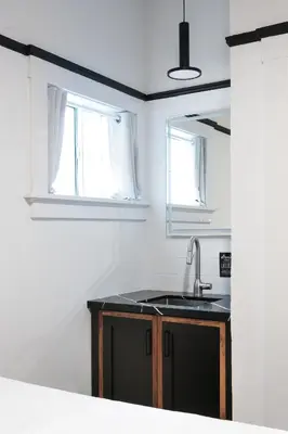 a kitchen with a sink and two windows at La Ventana Hotel in San Diego