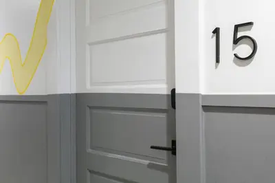 a white door with a number on it next to at La Ventana Hotel in San Diego