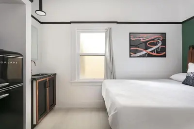 a bedroom with a bed and a window at La Ventana Hotel in San Diego