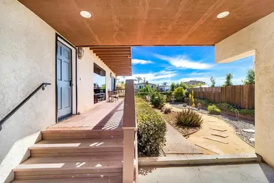 a porch of a home with a wooden walkway at Stylish & Bright 5 Star Location Ocean View Queen Beds in San Diego