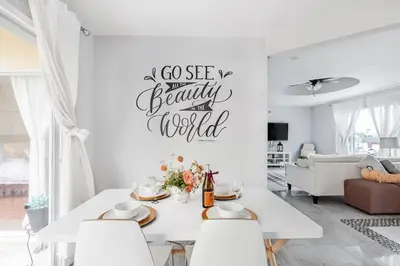 a white living room with a white table and chairs at Creative Haven Chic 3-Bedroom with Artistic Touches in San Diego