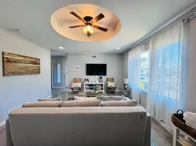 a living room with a couch and a ceiling fan at Creative Haven Chic 3-Bedroom with Artistic Touches in San Diego