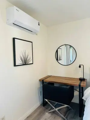 a room with a desk and a mirror on the wall at Sunny Retreat HUGE Single Level Home with large yard in San Diego
