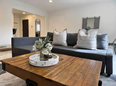 a living room with a couch and a coffee table at Sunny Retreat HUGE Single Level Home with large yard in San Diego