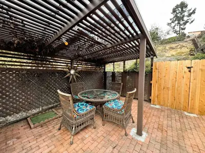 a patio with a table and chairs under a pergola at Sunny Retreat HUGE Single Level Home with large yard in San Diego