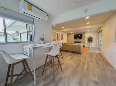 a kitchen and living room with a bar and chairs at Sunny Retreat HUGE Single Level Home with large yard in San Diego