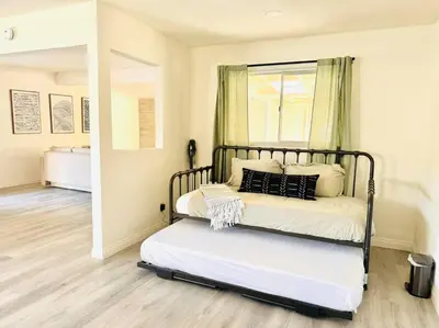 a bedroom with a bed with a black frame at Sunny Retreat HUGE Single Level Home with large yard in San Diego