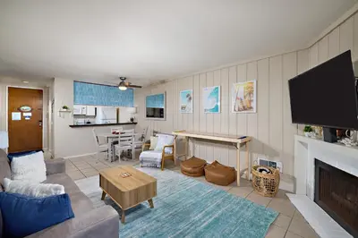 a living room with a couch and a tv at Oceanside Beach Condos in Oceanside