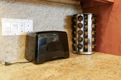 a toaster oven sitting on a counter next to a wall at Oceanside Beach Condos in Oceanside