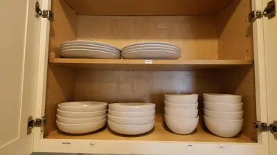 a cupboard filled with white bowls and plates at Exotic home Sdstay-com in Spring Valley