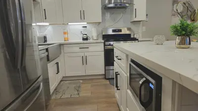 a kitchen with white cabinets and a dishwasher at Exotic home Sdstay-com in Spring Valley
