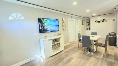 a dining room with a table and a tv on a wall at Exotic home Sdstay-com in Spring Valley