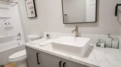a white bathroom with a sink and a toilet at Exotic home Sdstay-com in Spring Valley
