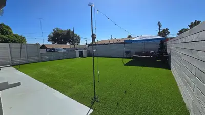 a yard with green grass and a fence at Exotic home Sdstay-com in Spring Valley