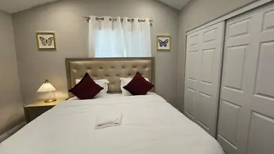 a bedroom with a large white bed with red pillows at Exotic home Sdstay-com in Spring Valley