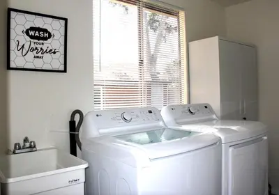 a laundry room with a washing machine and a sink at San Diego Fun-Gameroom & Gazebo-Centrally Located! in San Diego