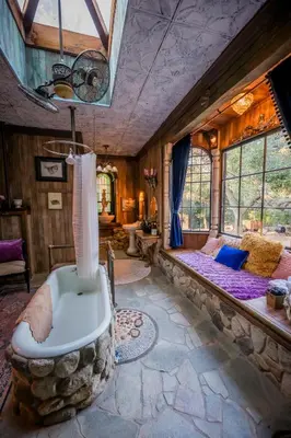 a bathroom with a bath tub in a room at Historic Farmhouse on 5 Peaceful Acres with Ancient Oaks & Creek above Temecula in Temecula
