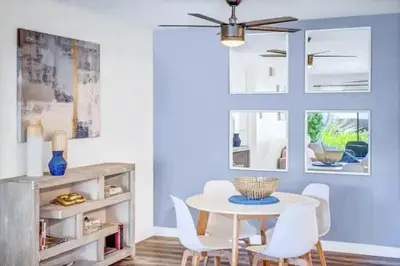 a dining room with a table and white chairs at Resort Living with Pool & Tennis Minutes to Del Mar Beaches in San Diego