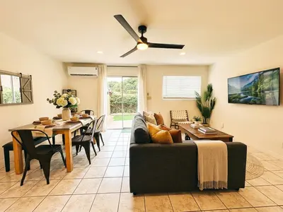 a living room with a couch and a dining room table at Pet friendly Spacious 3Bed with HUGE Back Yard in San Diego