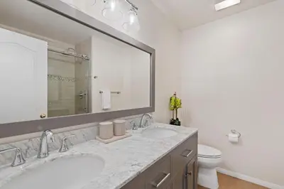 a bathroom with two sinks and a mirror and a toilet at Del Mar Deluxe Palace - Majestic - Iconic- Retreat in San Diego