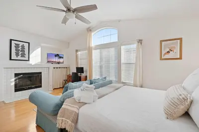 a bedroom with a large bed and a fireplace at Del Mar Deluxe Palace - Majestic - Iconic- Retreat in San Diego