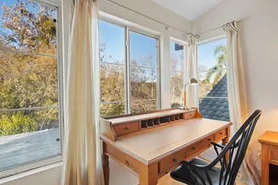 a wooden desk in a room with windows at Del Mar Deluxe Palace - Majestic - Iconic- Retreat in San Diego