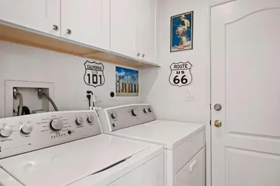 a white laundry room with a washer and dryer at Del Mar Deluxe Palace - Majestic - Iconic- Retreat in San Diego
