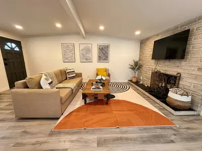a living room with a couch and a fireplace at Comfortable 2Bed in Duplex with private Sunroom in San Diego