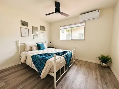 a bedroom with a bed and a ceiling fan at Comfortable 2Bed in Duplex with private Sunroom in San Diego
