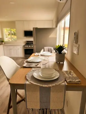 a table with plates on it in a kitchen at Comfortable 2Bed in Duplex with private Sunroom in San Diego