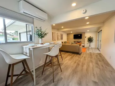 a kitchen and living room with a counter and chairs at Comfortable 2Bed in Duplex with private Sunroom in San Diego