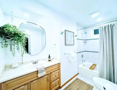 a white bathroom with a sink and a mirror at Del Mar Coastal Haven in San Diego