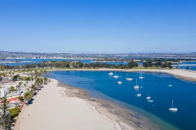 an aerial view of a beach with boats in the water at Bayfront Apartment Steps to the Sand - Ultimate Coastal Living in San Diego