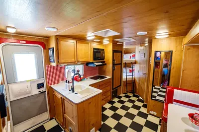 a kitchen with a sink and a counter top at Darling Daisy Retro RV Adventure in El Cajon