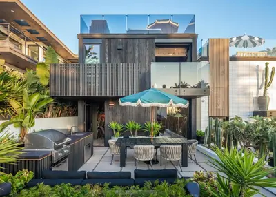a house with a patio with a table and chairs at Nord Moonlight Beach Luxury Home in Encinitas