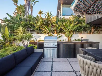 a outdoor kitchen with a couch and a stove at Nord Moonlight Beach Luxury Home in Encinitas