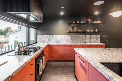 a kitchen with orange cabinets and a counter top at Nord Moonlight Beach Luxury Home in Encinitas