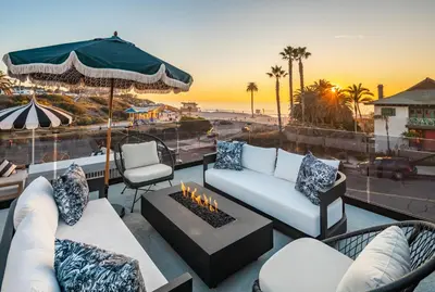 a living room with a couch and a fire place at Nord Moonlight Beach Luxury Home in Encinitas