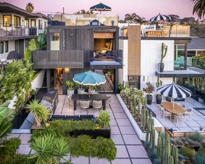 an aerial view of a building with tables and umbrellas at Nord Moonlight Beach Luxury Home in Encinitas