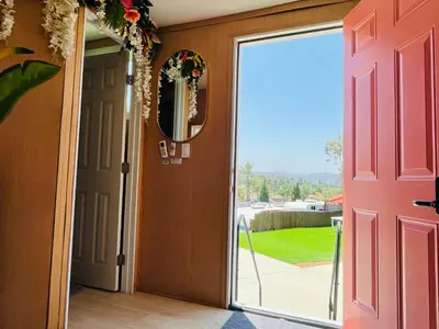an open door with a view of a yard at Bird of Paradise Retreat with stunning mountain views in El Cajon