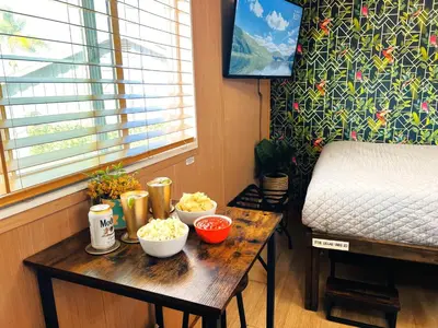 a table with bowls of food on it next to a bed at Bird of Paradise Retreat with stunning mountain views in El Cajon