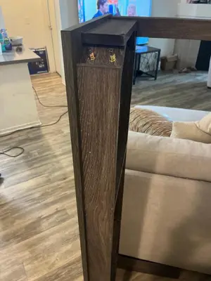 a wooden stand with a black top next to a couch at Private stay SD in San Diego
